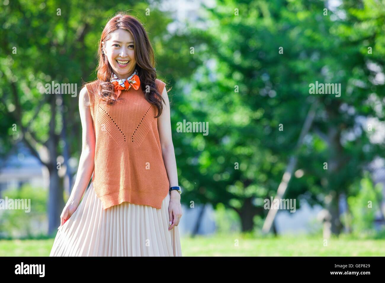 Woman standing at a park Stock Photo - Alamy