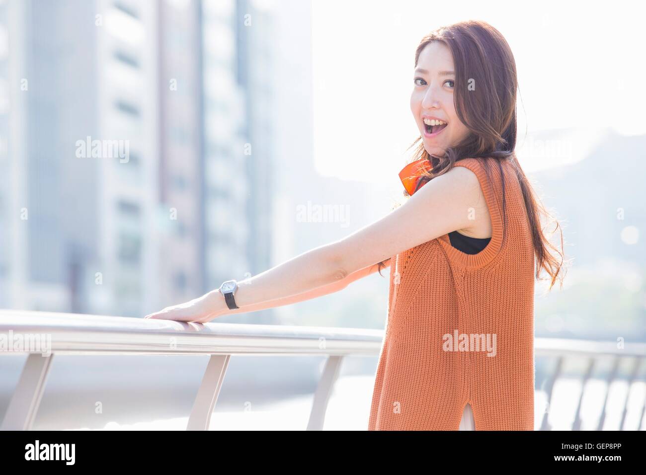 Woman standing at river side in the town Stock Photo - Alamy