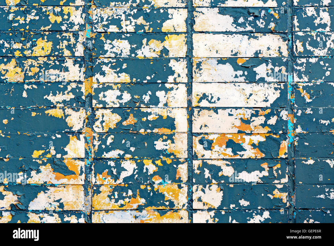colorful background of rusty tiled wall with peeling off paint Stock Photo
