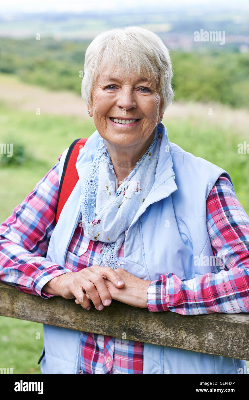 Portrait Of Senior Woman Hiking In Countryside Stock Photo