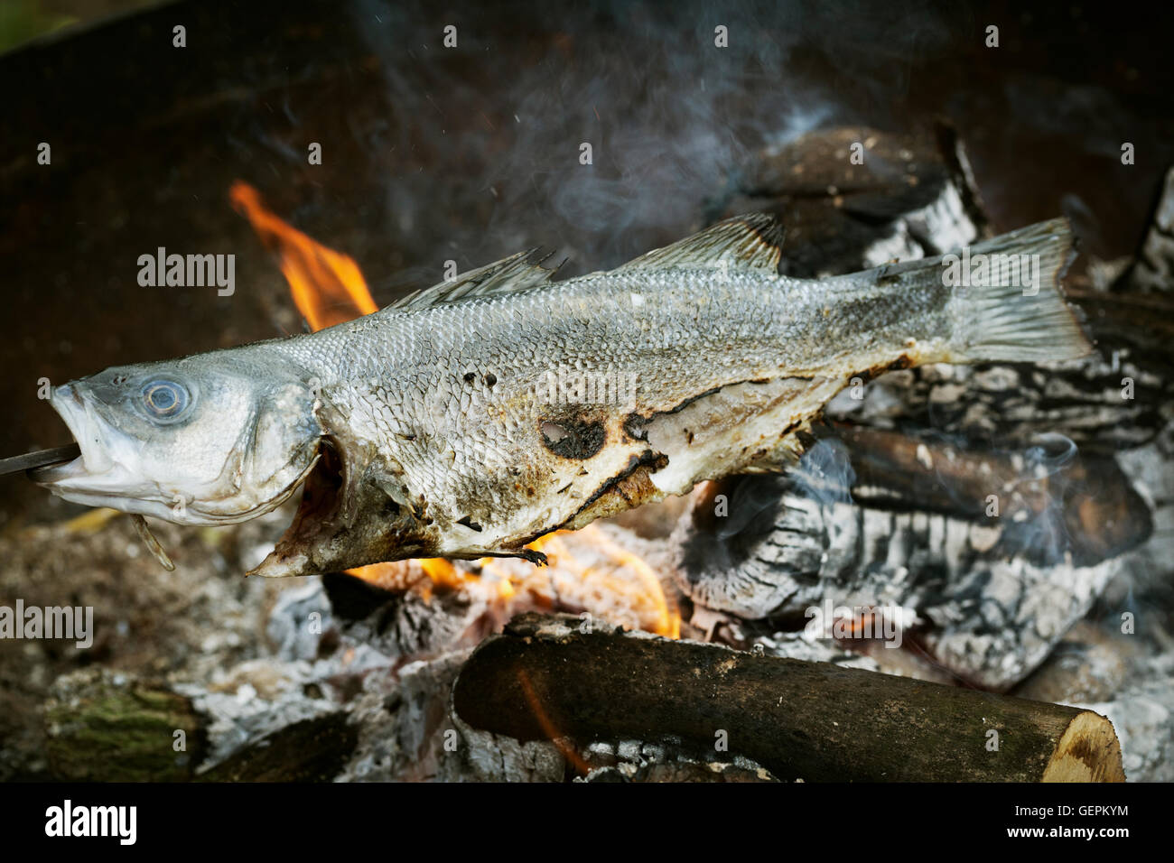 Whole fish grilled on a barbecue. Stock Photo