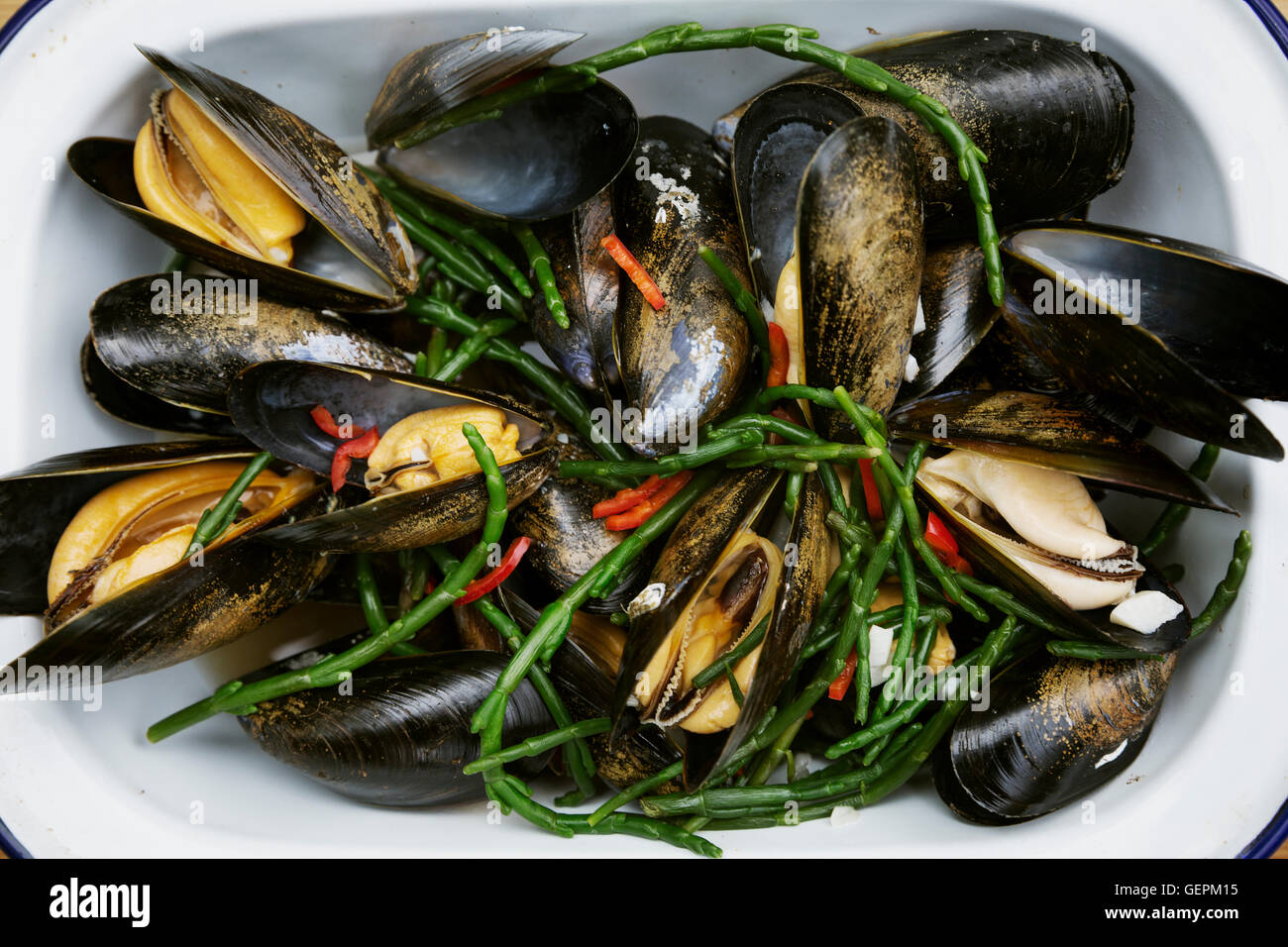 Steamed Black Mussels with samphire. Stock Photo
