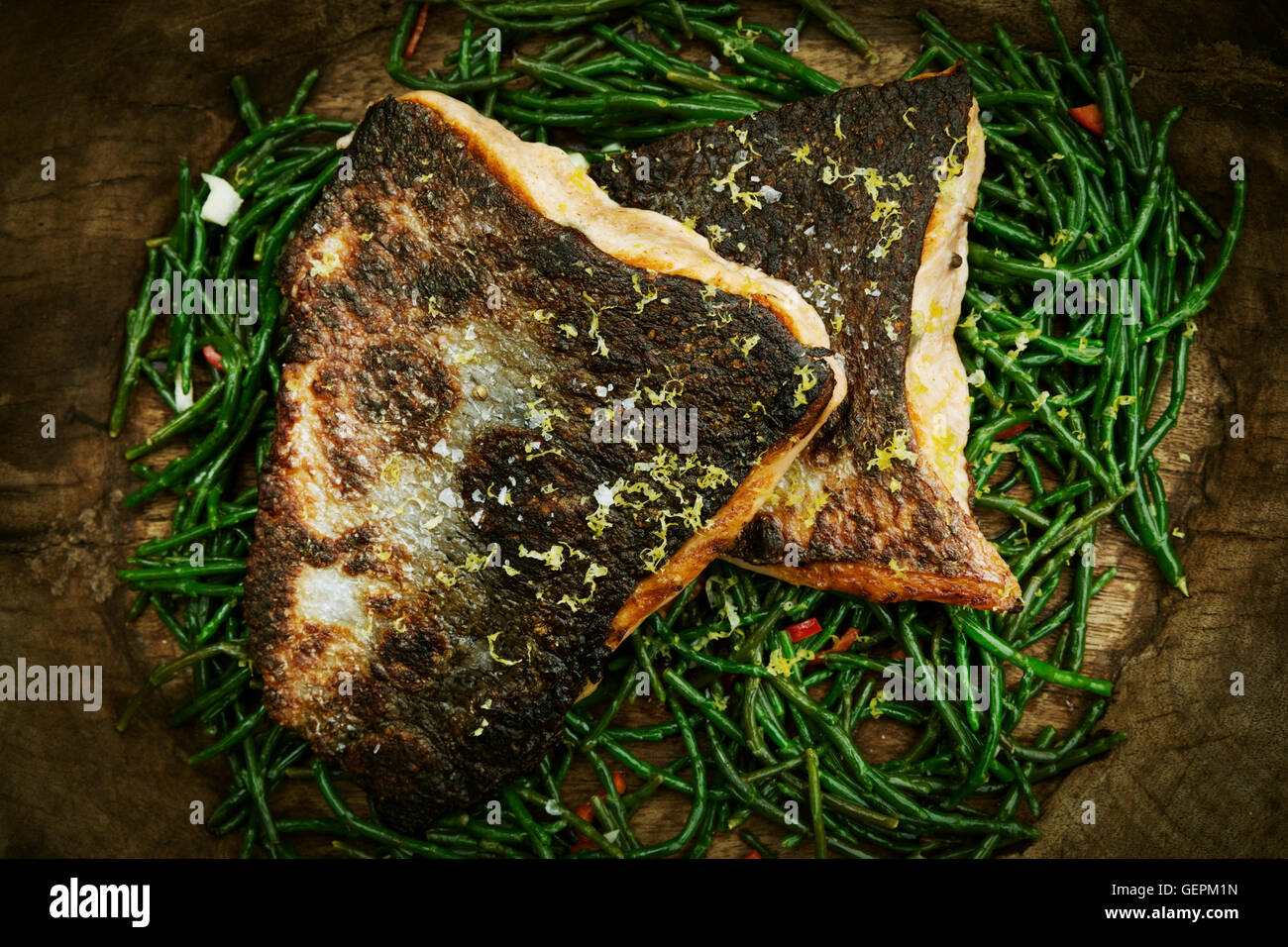 Close up of grilled fish fillets with crispy skin on a bed of samphire Stock Photo Alamy