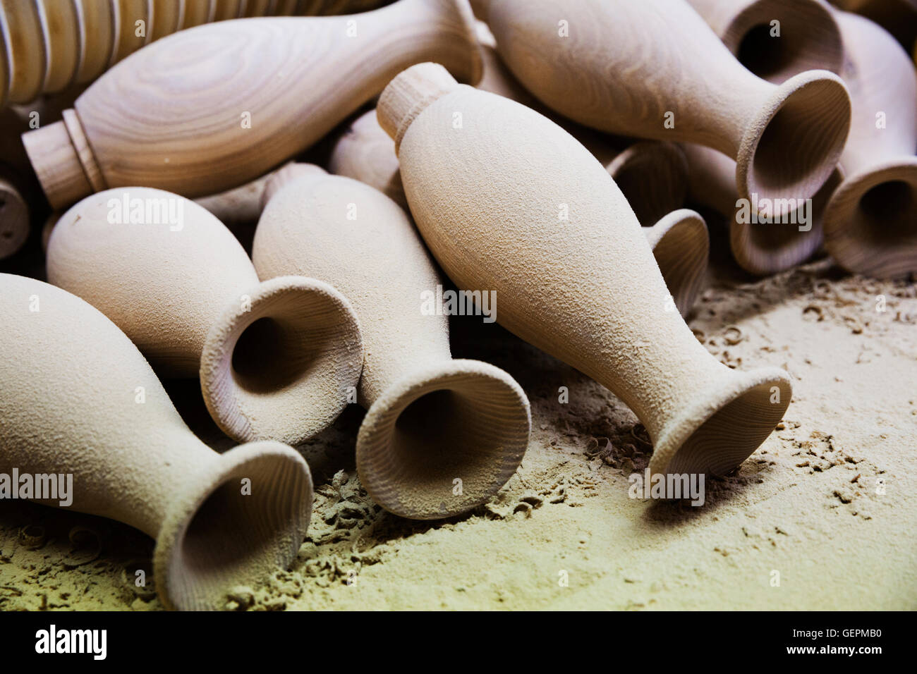 Close up of a pile of turned wooden pieces, spindles lying in a carpentry workshop. Stock Photo