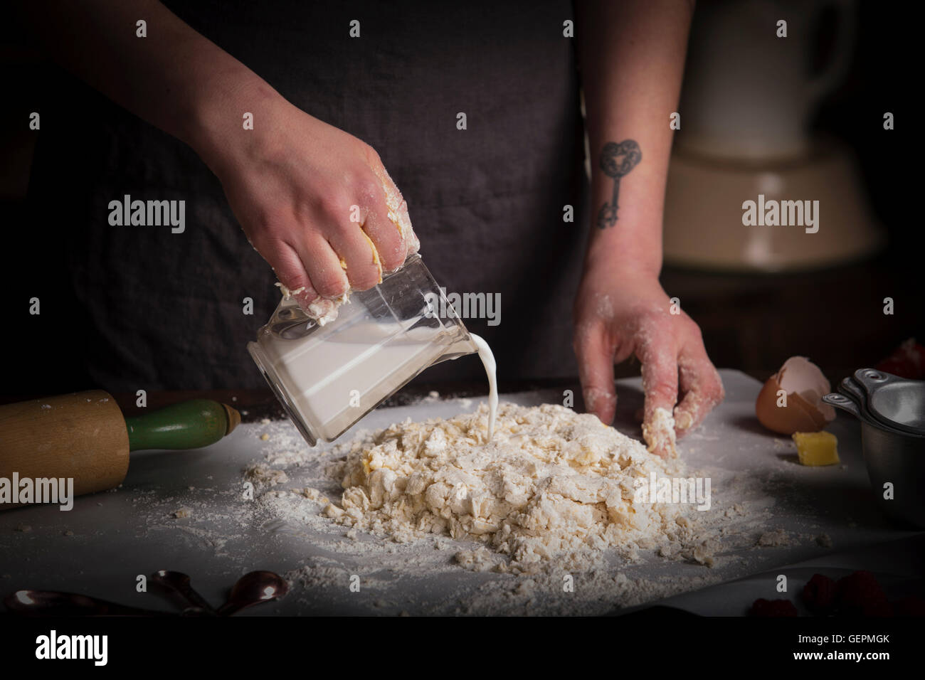 Valentine's Day baking, woman preparing dough for biscuits, pouring