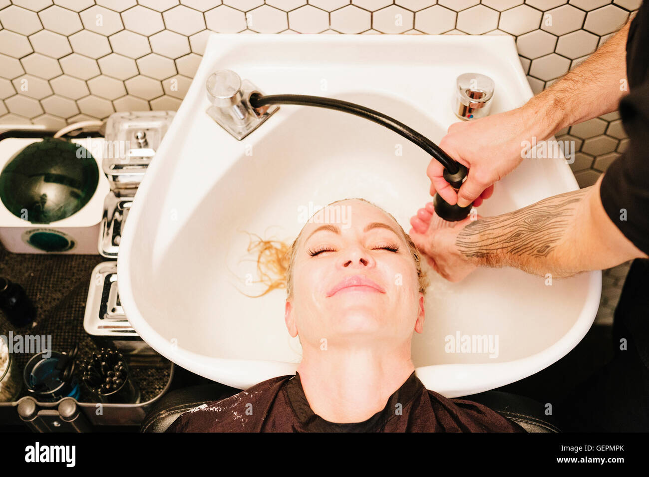 A woman with short hair at the hairdressers Stock Photo