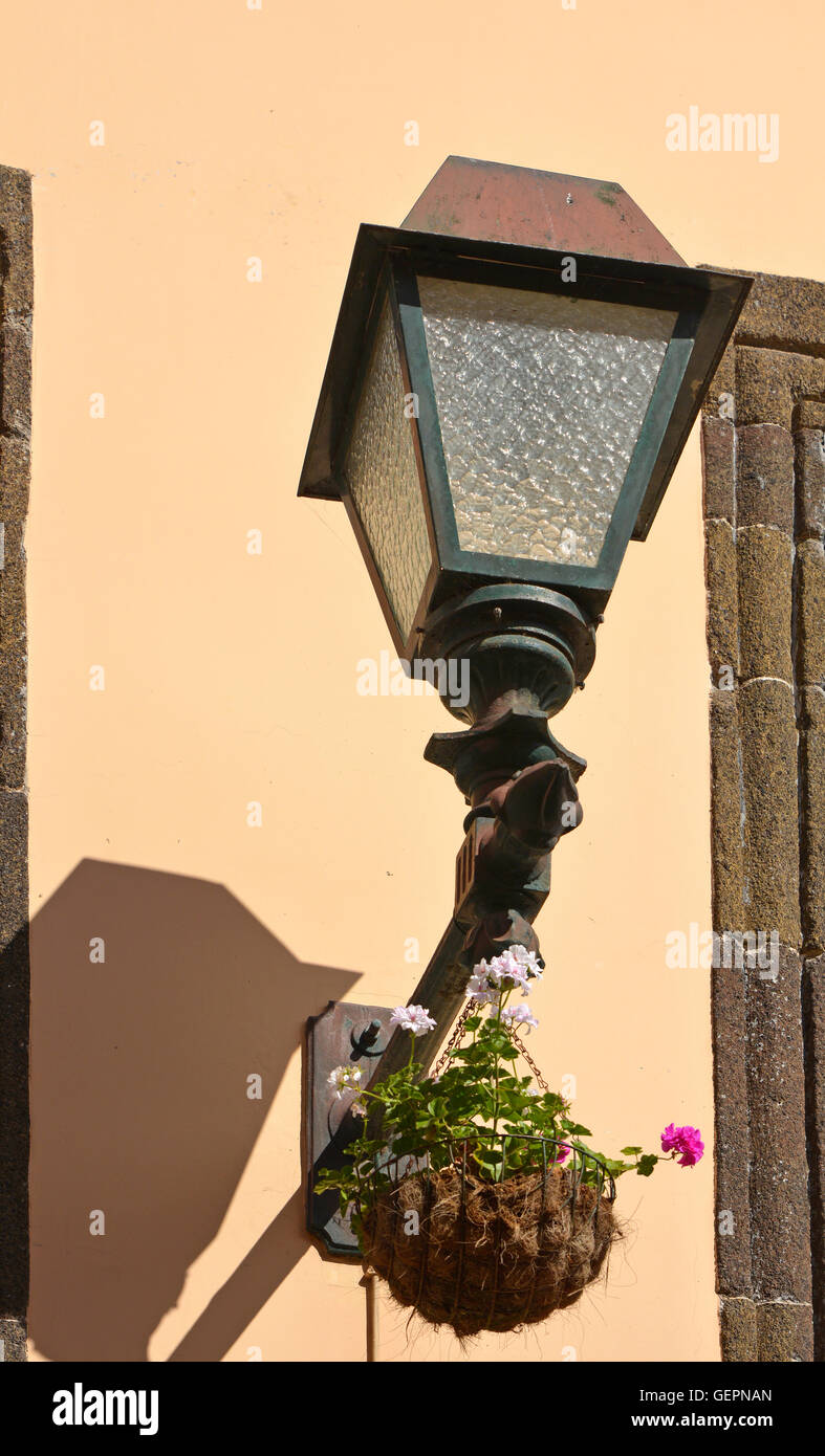 Electric street lamp on wall of building in Funchal, Madeira, Portugal Stock Photo
