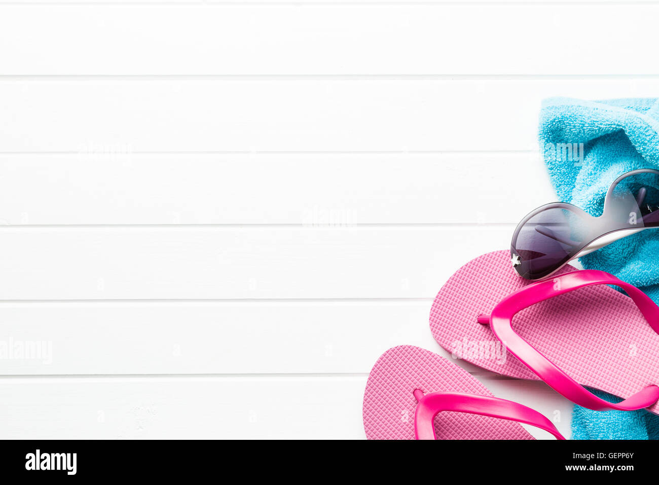 Pink flip flops with towel and sunglasses on white floor Stock Photo ...