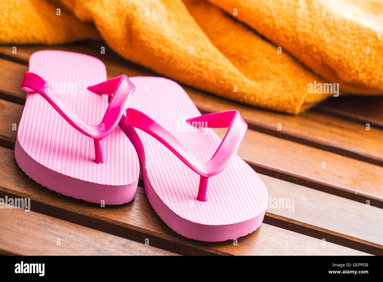 Pink flip flops on wooden floor. Stock Photo