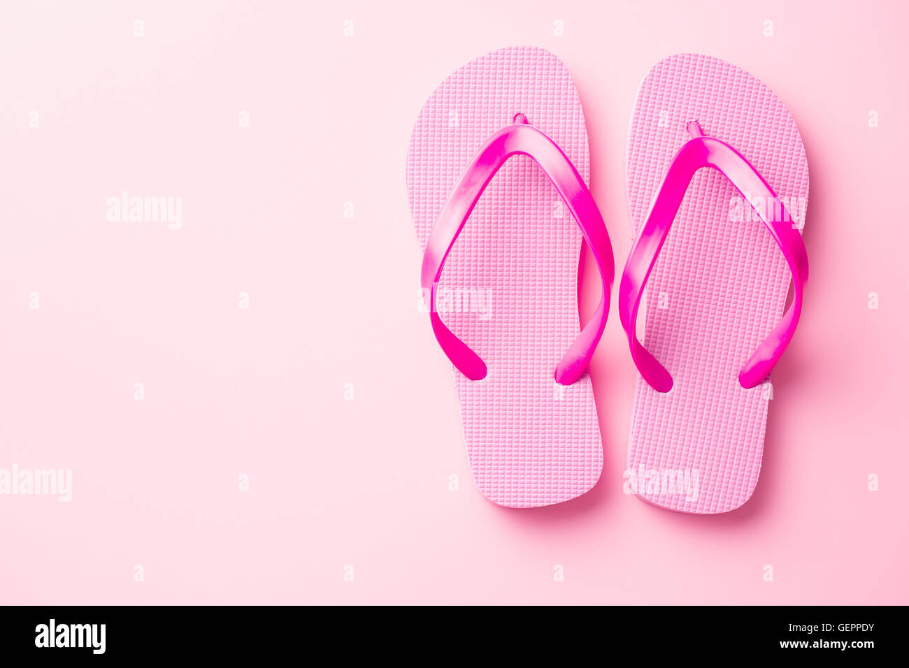 Pink flip flops on pink background. Stock Photo