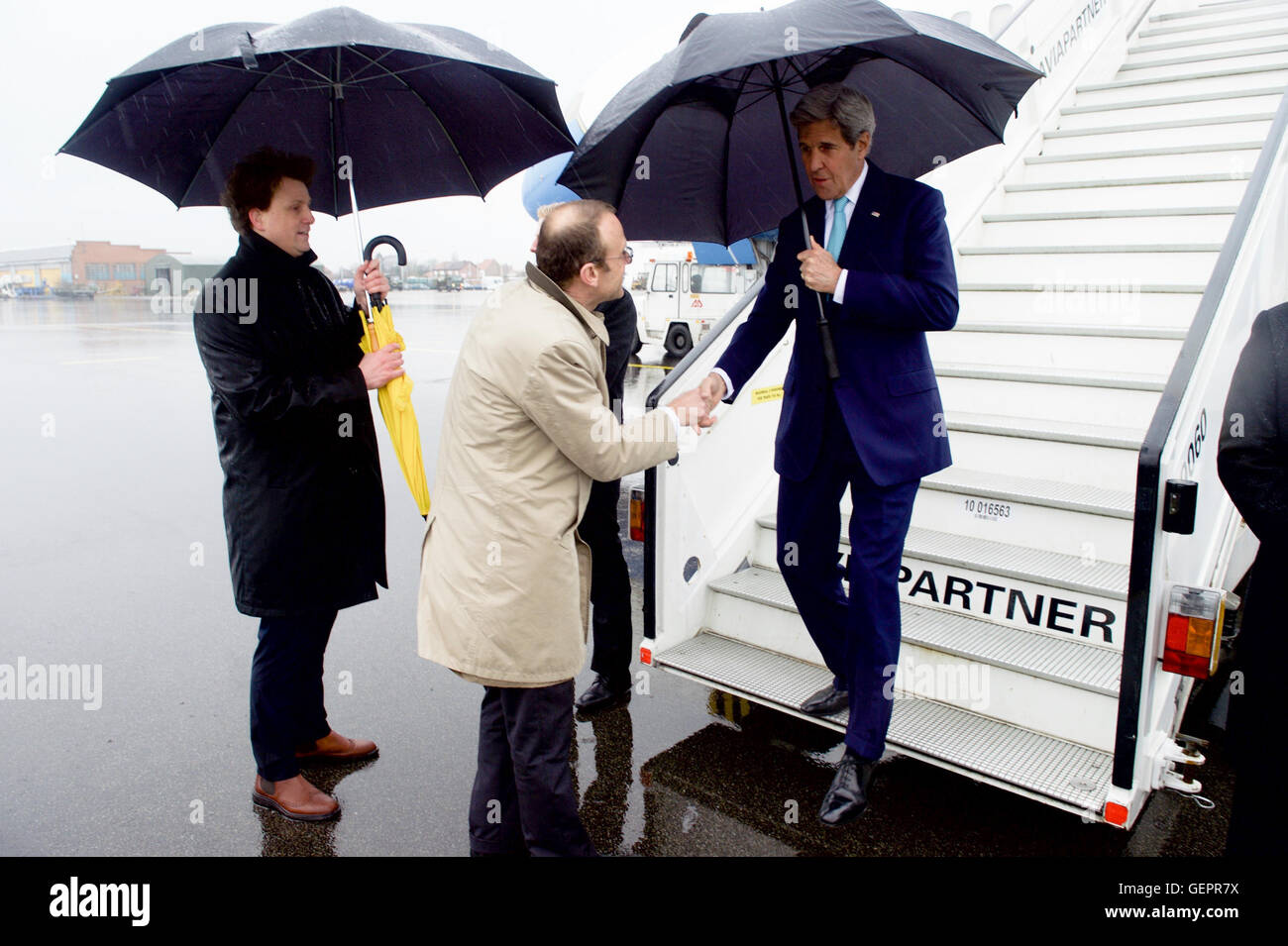 Belgian Ministry of Foreign Affairs Chief of Protocol Huygelen Greets Secretary Kerry As He Arrives at Brussels National Airport in Brussels, Belgium Stock Photo