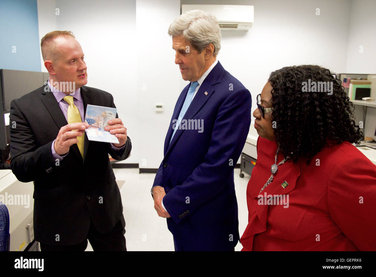 Miami Passport Agency Director Dooley and Deputy Director Ward Show Secretary Kerry a Blank Passport in Their Manufacturing Room During His Day Trip to the City Stock Photo