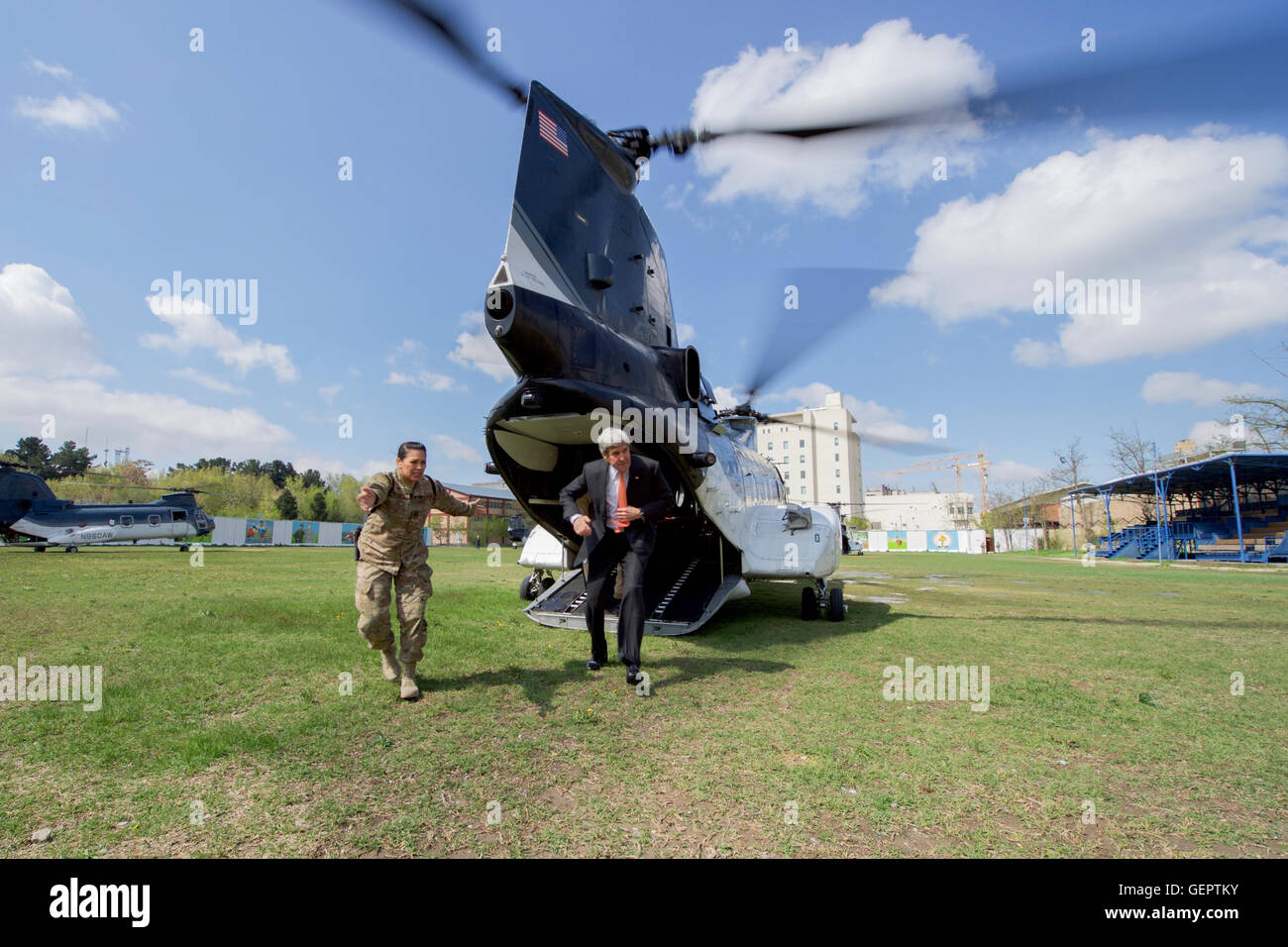 Secretary Kerry Disembarks From Helicopter Upon Arrival at Camp Resolute Support Landing Zone in Kabul Stock Photo