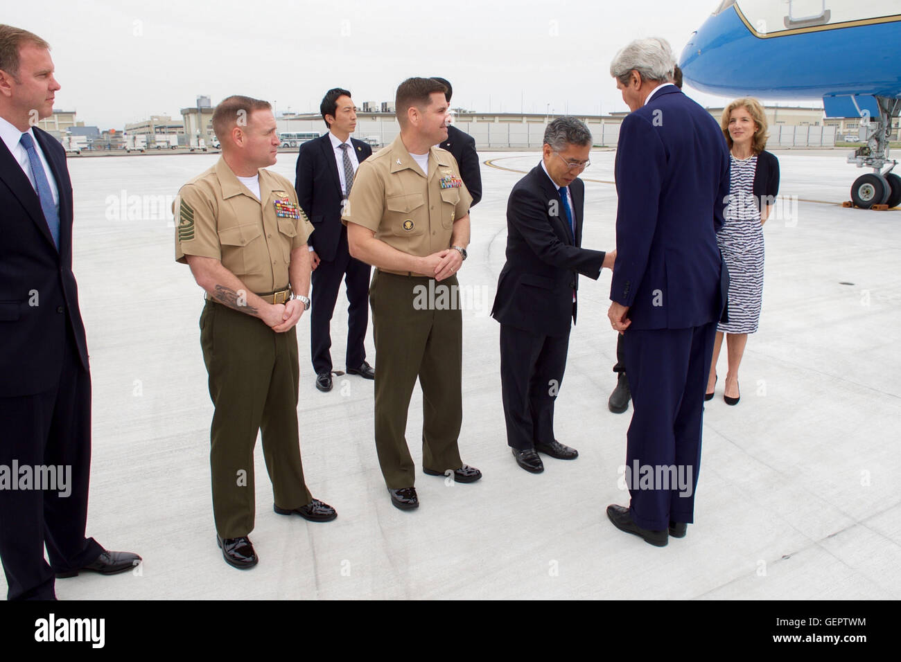 Secretary Kerry is Greeted by Japanese Ministry of Foreign Affairs Chief of Protocol Shimazaki Upon Arrival in Hiroshima Stock Photo