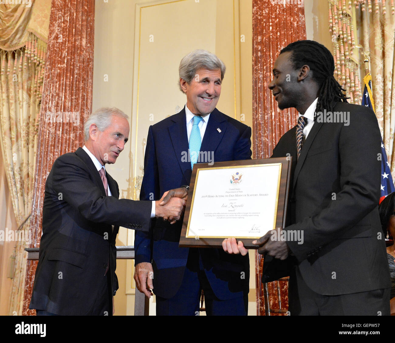 Secretary Kerry Looks on as Senator Corker Shakes Hands With 2016 TIP Report Hero Issa Kouyate of Senegal in Washington Stock Photo