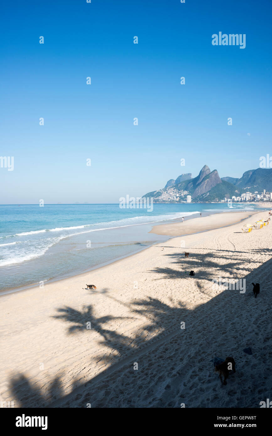 Ipanema Beach, Rio de Janeiro, Brazil - scenic view with Two Brothers Mountain and shadow of palm tree Stock Photo