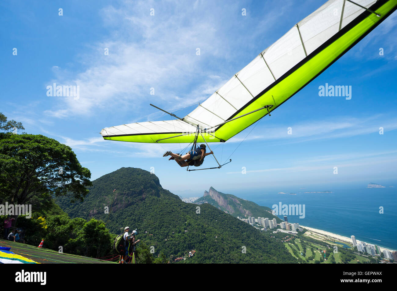Hangglider taking off from the ramp at Pedra Bonita, in the Tijuca National Forest, heading toward the beach in Rio de Janeiro Stock Photo