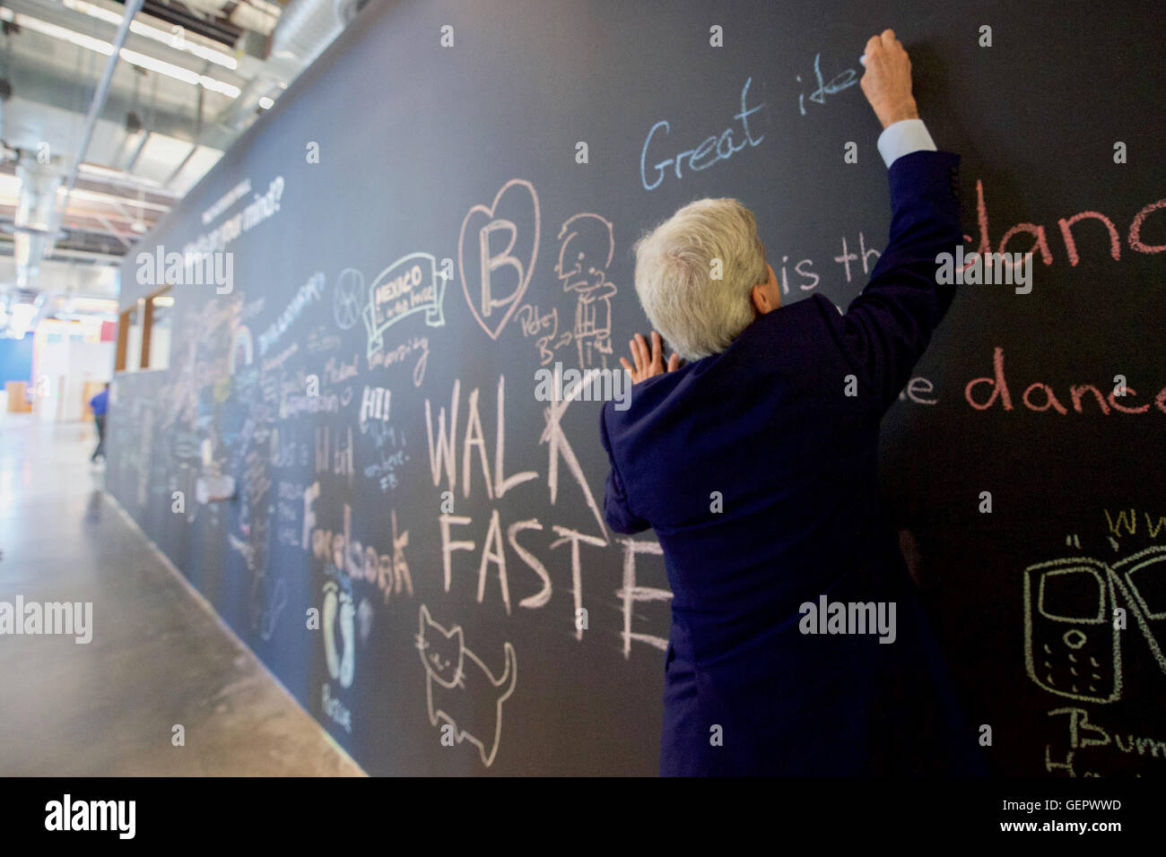 Secretary Kerry Signs a Message on Facebook's Wall at Their New Headquarters in Menlo Park Stock Photo