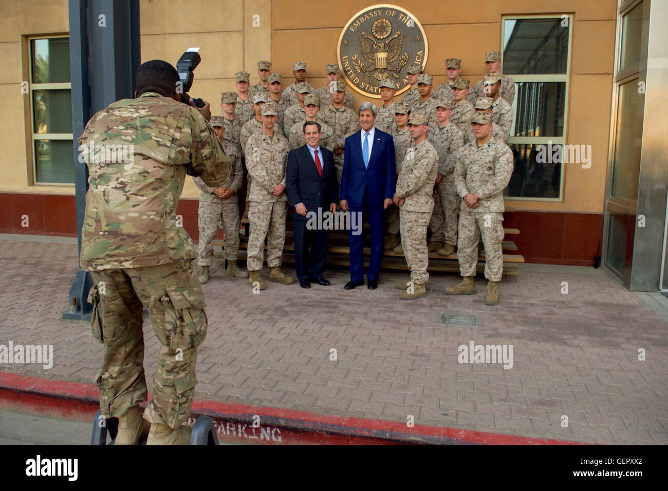 U.S. Army SPC Turnbow Takes a Photo of Secretary Kerry and U.S. Ambassador Jones With Members of the Marine Security Guard Detachment in Baghdad Stock Photo