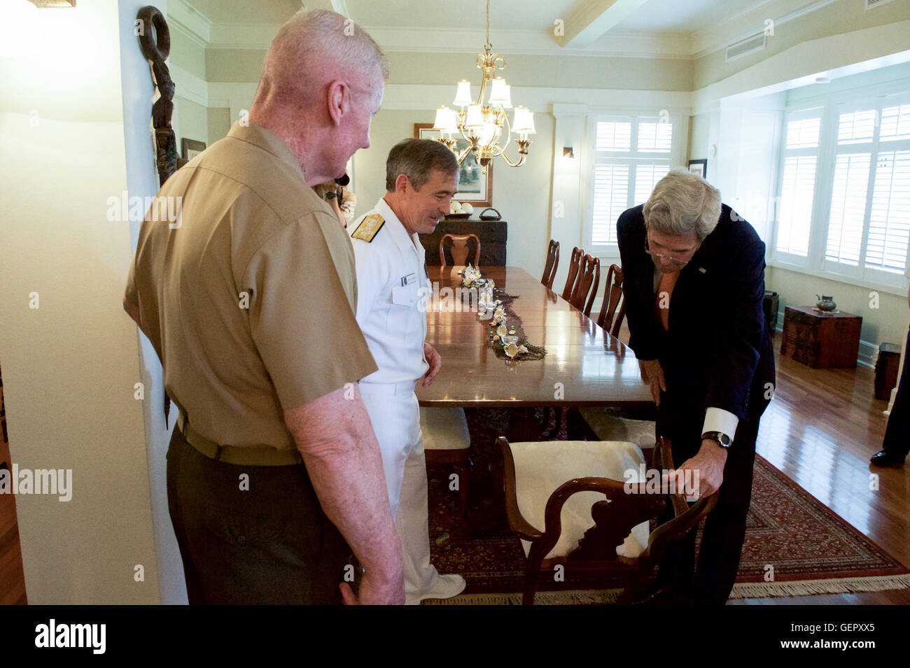 U.S. Navy Admiral Harris, With Lieutenant General Toolan, Shows Secretary Kerry the Nameplates Revealing the Dignitaries Who Have Sat at the Dining Room Table in His Quarters at Joint Base Pearl Harbor-Hickam in Hawaii Stock Photo