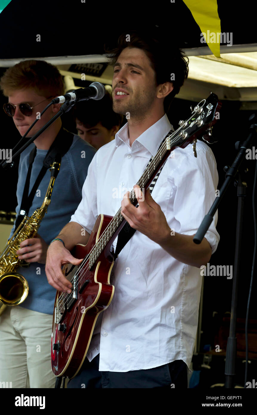 The bass guitarist and sax player with the band Jambouree playing at