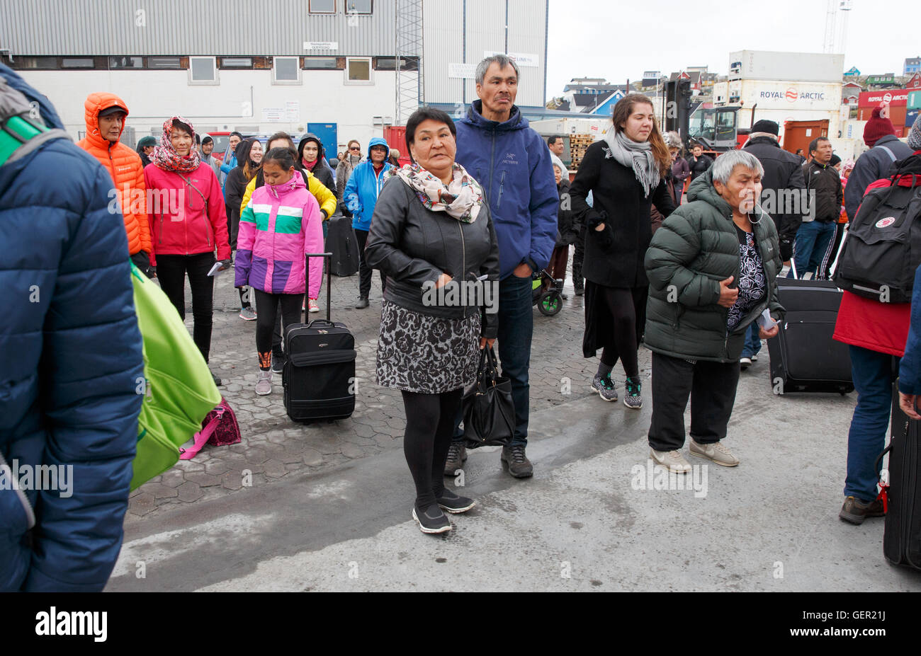 People wait for arrivals at the ferry port, Aasiaat, Greenland Stock Photo