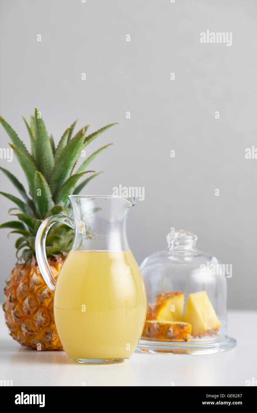 https://c8.alamy.com/comp/GER287/glass-jug-with-pineapple-juice-and-fruit-on-table-GER287.jpg