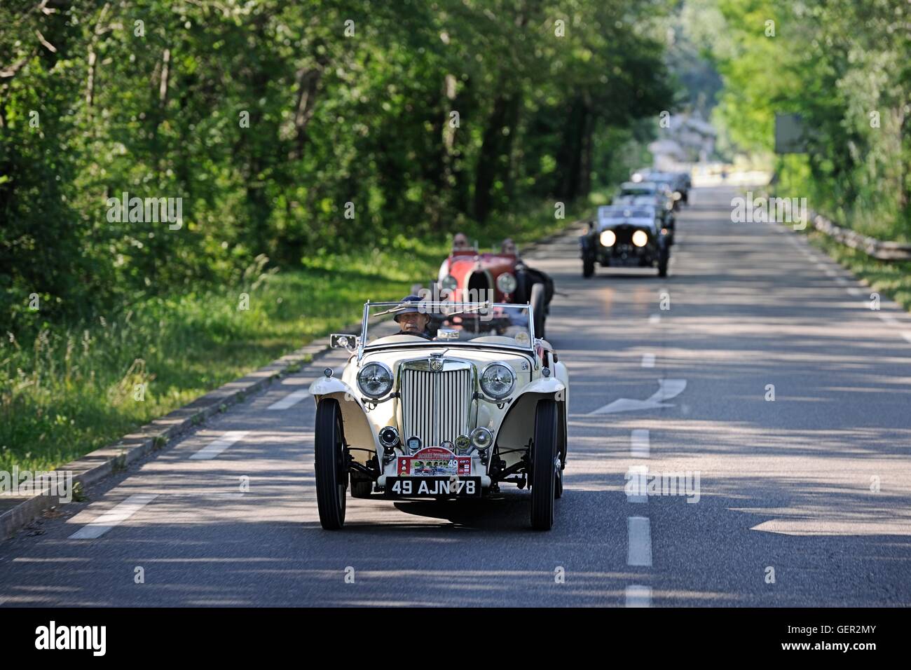 Prewar MG with Bugatti and other classic cars behind diving on a classic car rally in the south of France Stock Photo