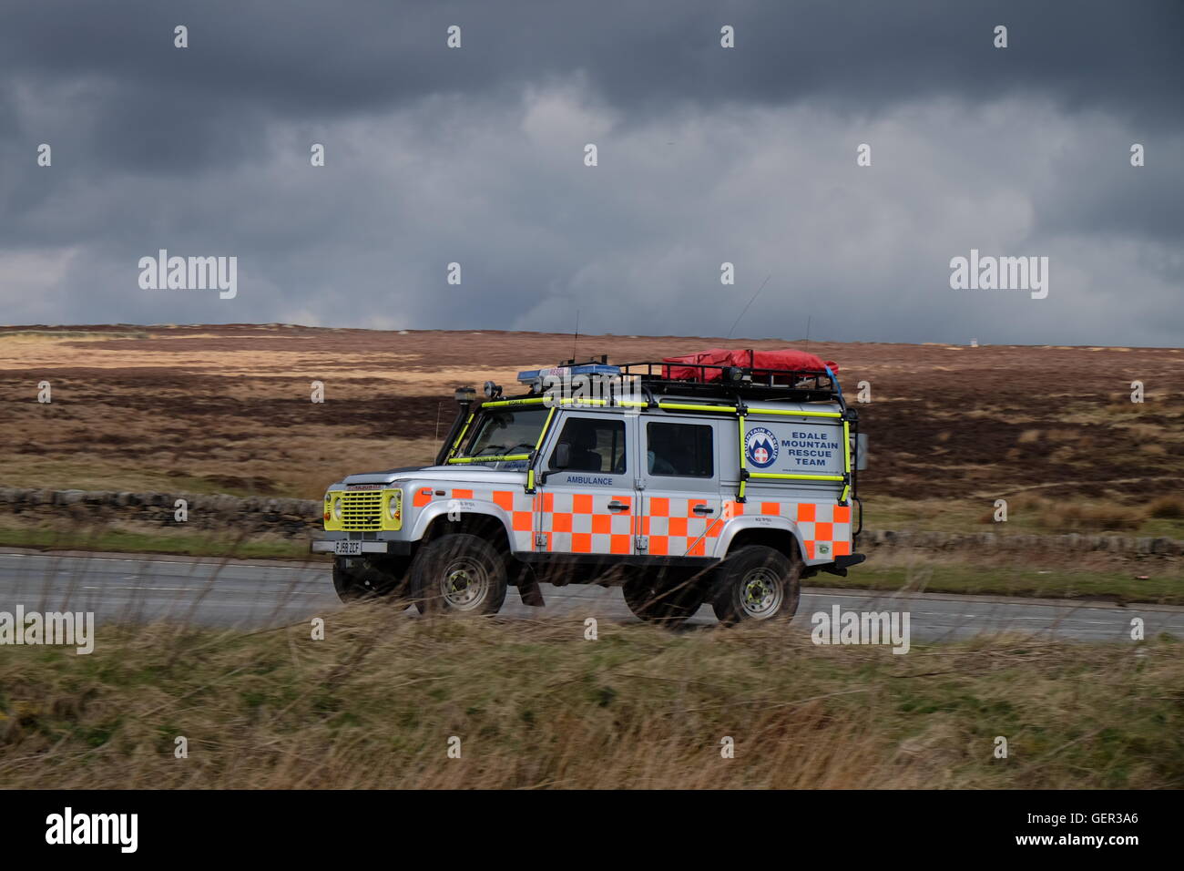 Edale Mountain Rescue Land Rover driving along a Peak District moorland road Stock Photo
