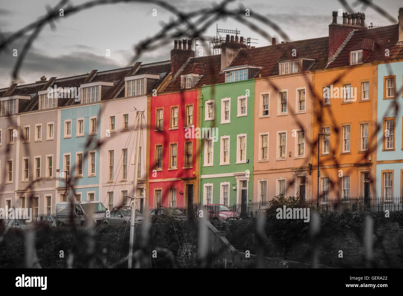 Colorful homes behind barbed wire in Bristol harbour, England, UK Stock Photo