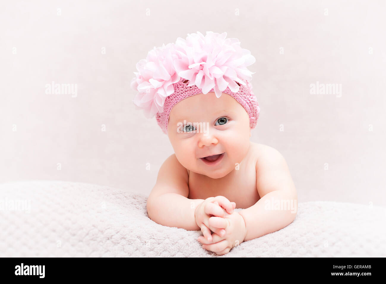 portrait of caucasian newborn with pink flower woolen hat Stock Photo