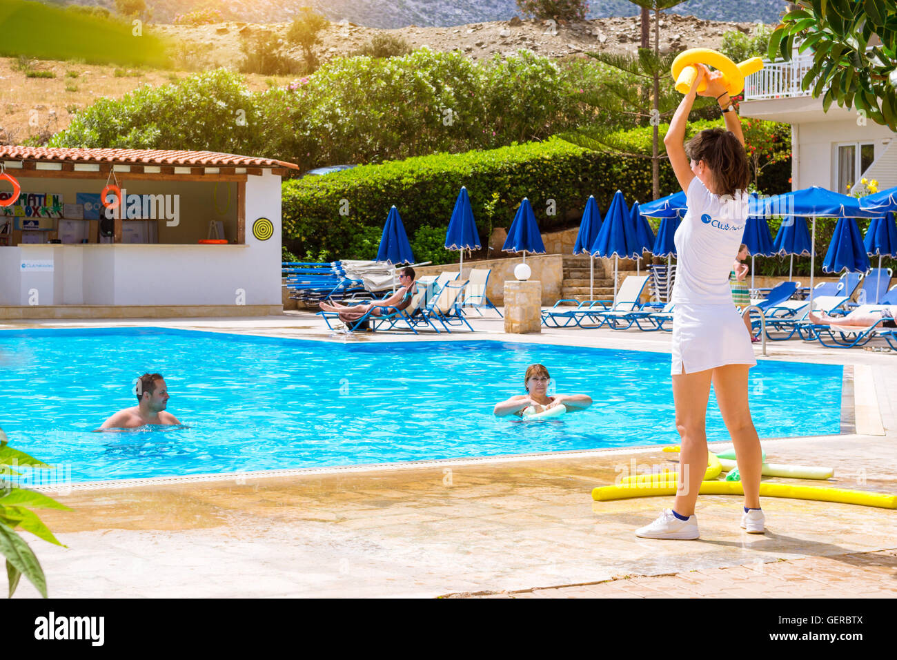 BALI, GREECE - APRIL 29, 2016: Animation at Resort hotel Atali Village 4 star. Cute girl in white beach suit conducts aerobic Stock Photo