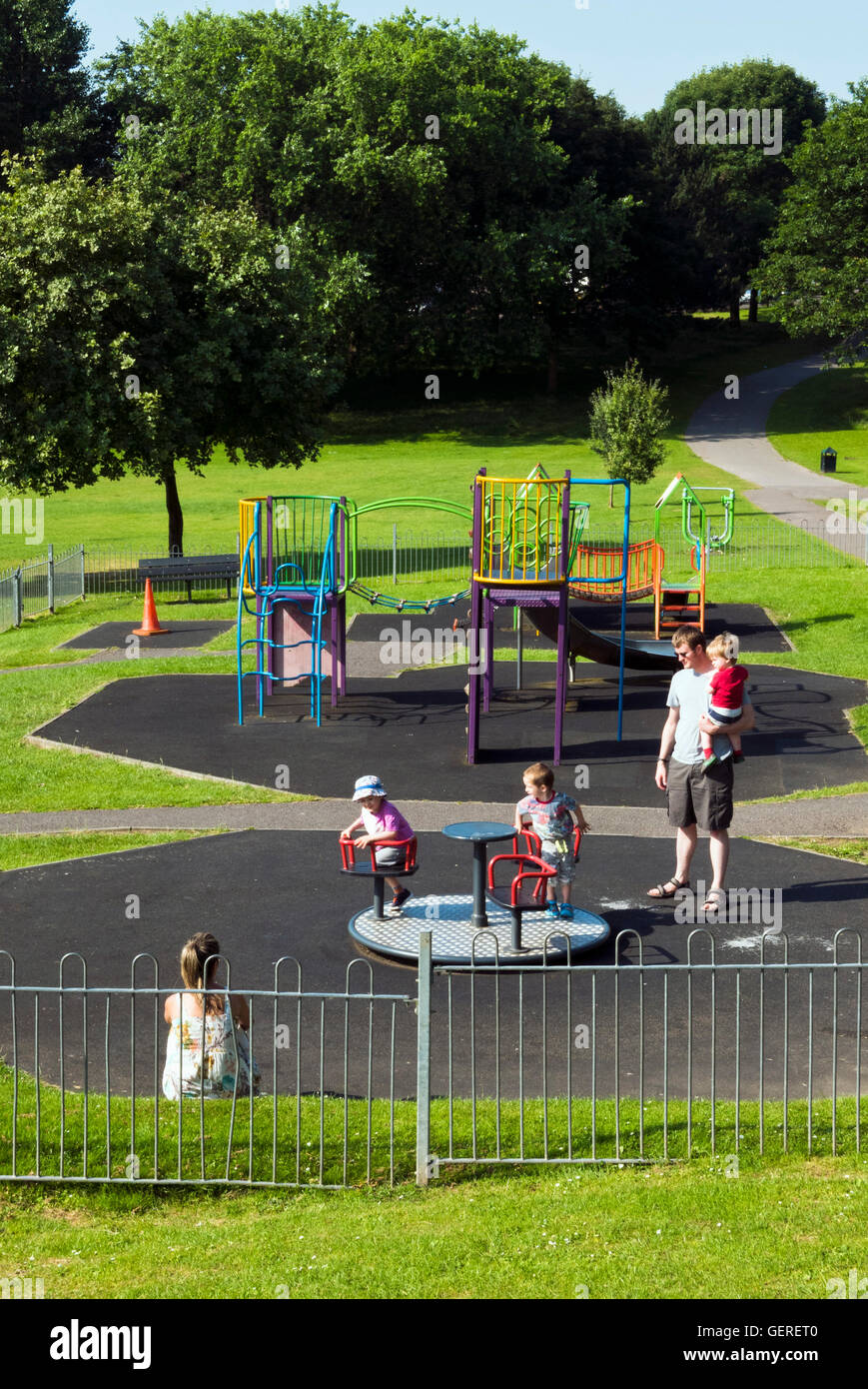 Family playing in a playground, Kingswood Park, Bristol, UK Stock Photo