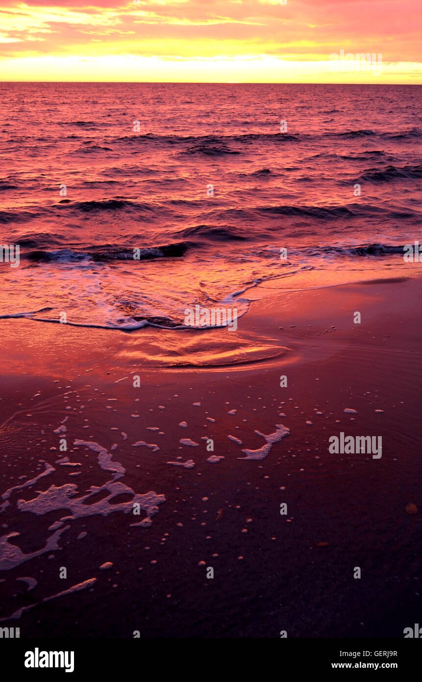 Sea Waves During A Colorful Sunset Over A Beautiful And Romantic Beach Stock Photo Alamy