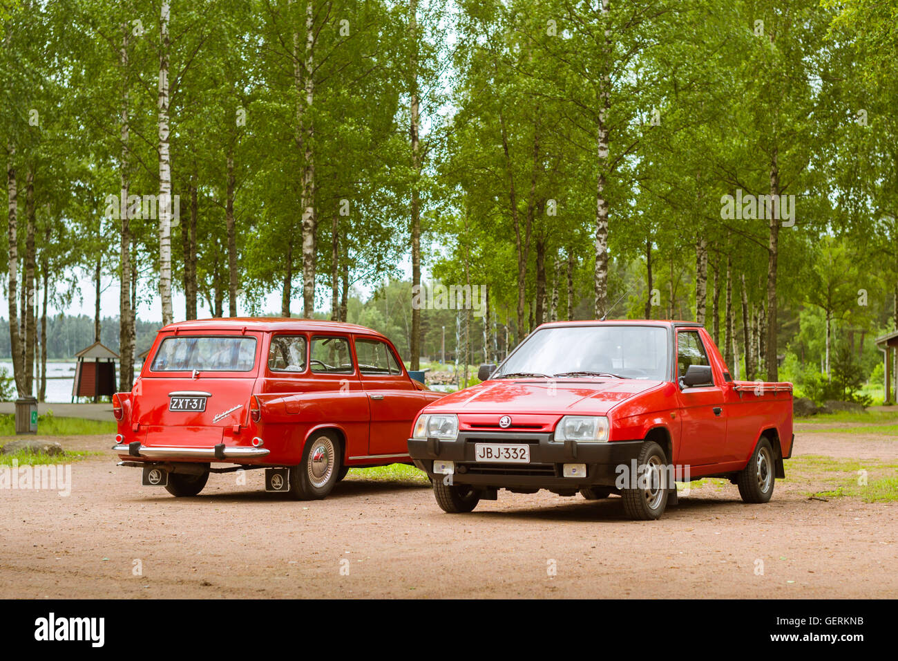 KOTKA, FINLAND - JUNE 14, 2014: Two red Skoda Felicia coupe wagon and pickup parked on shore of Finnish gulf. Festival Stock Photo