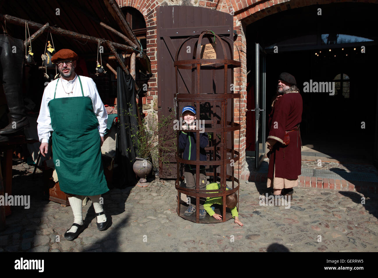 Rabenstein, Germany, children are locked up in a medieval festival in a cage Stock Photo