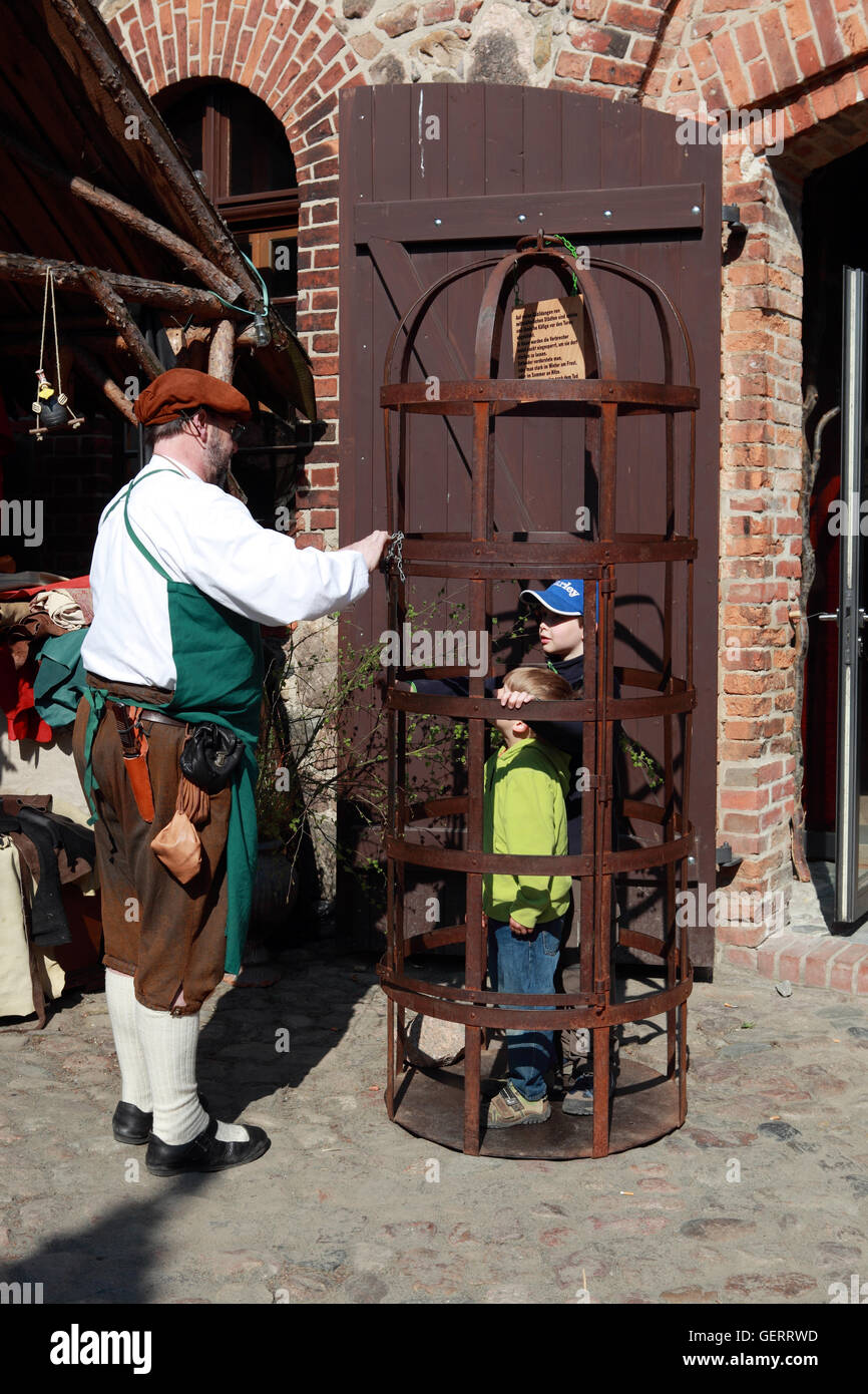 Rabenstein, Germany, children are locked up in a medieval festival in a cage Stock Photo