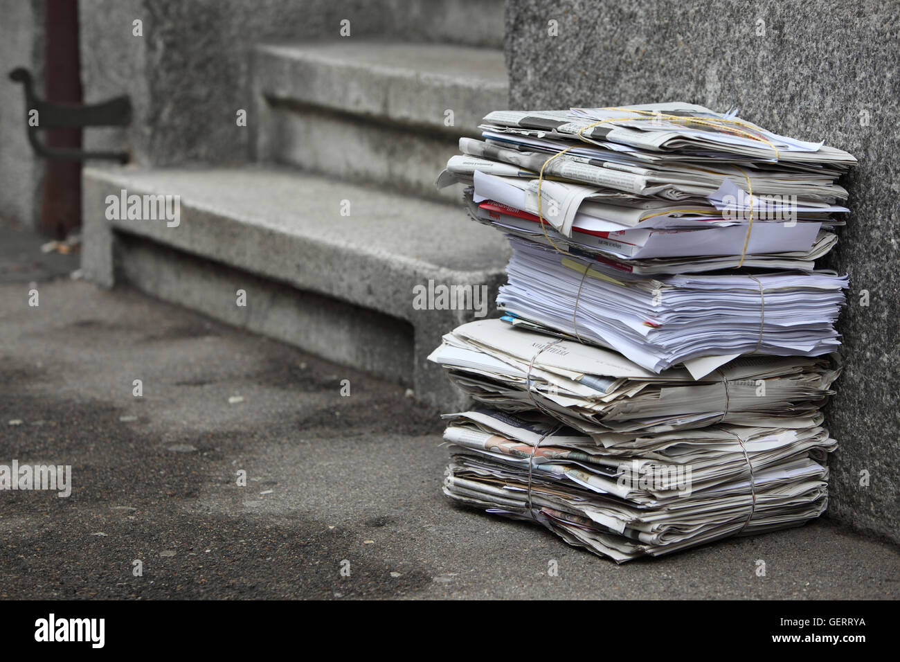 Zuerich, Switzerland, Zeitungsstapel leaning against a house wall Stock Photo