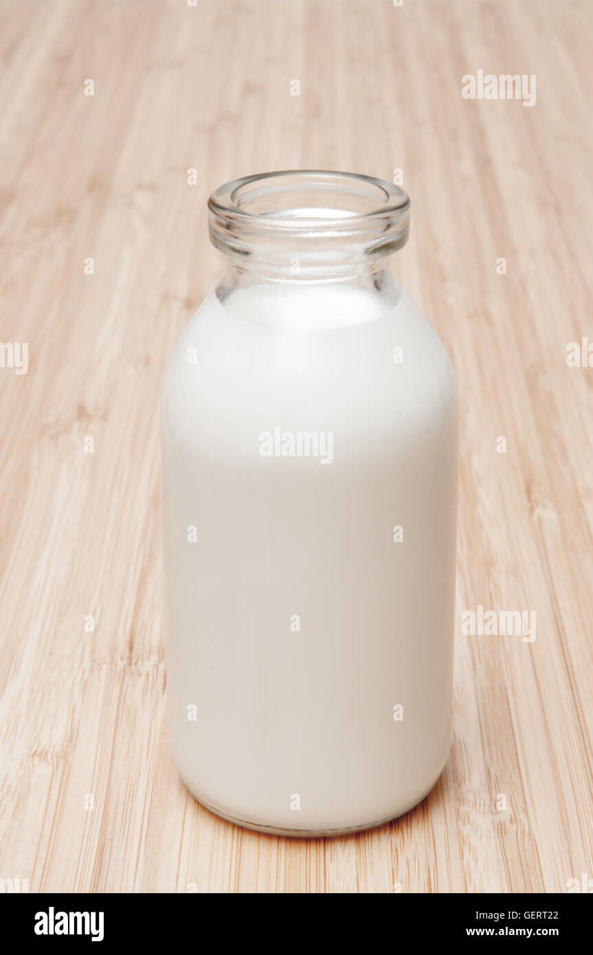 Bottle of milk on a a wooden table Stock Photo