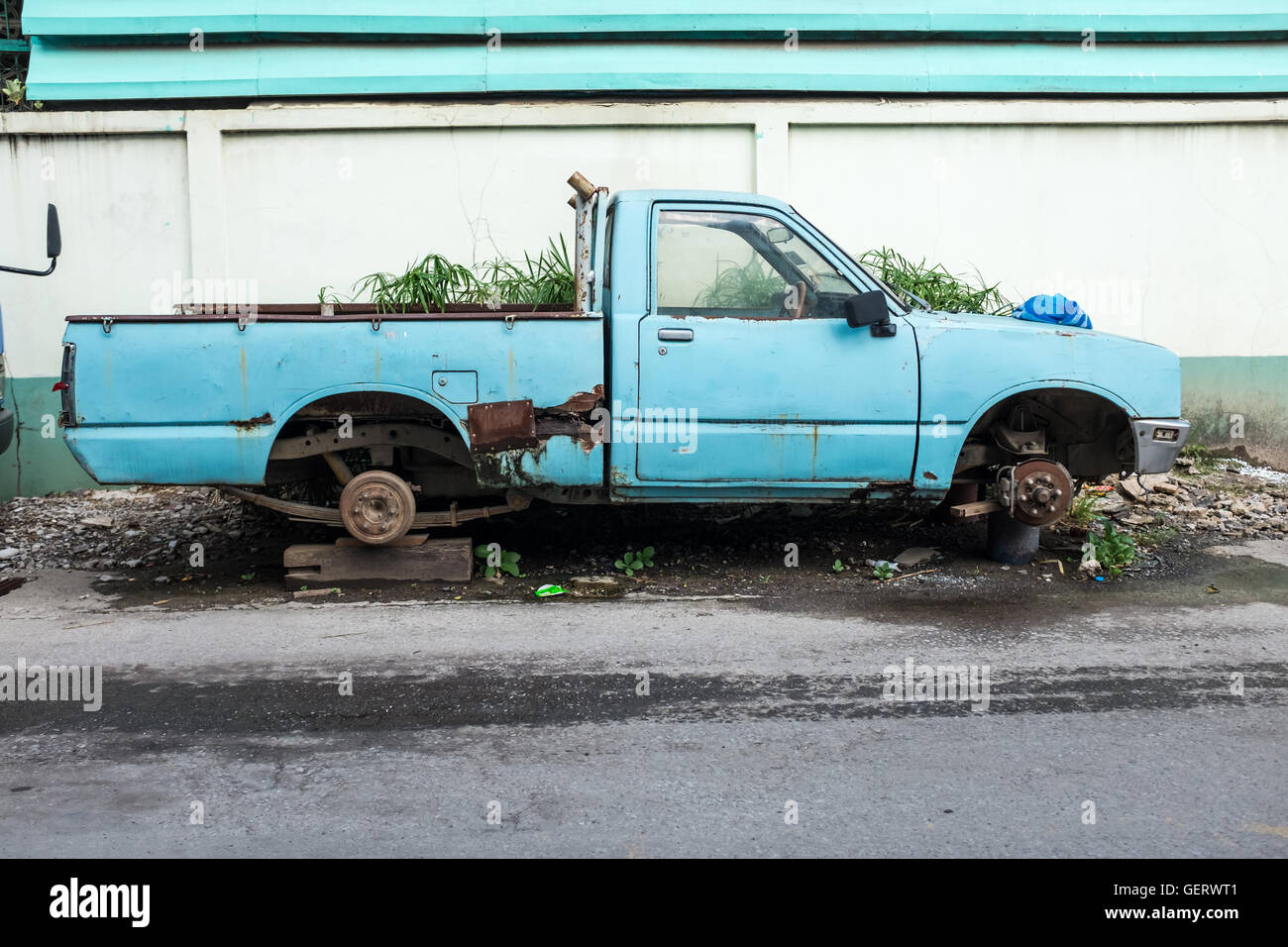 Old blue pick up truck with no wheels,Chiang Mai Thailand Stock Photo