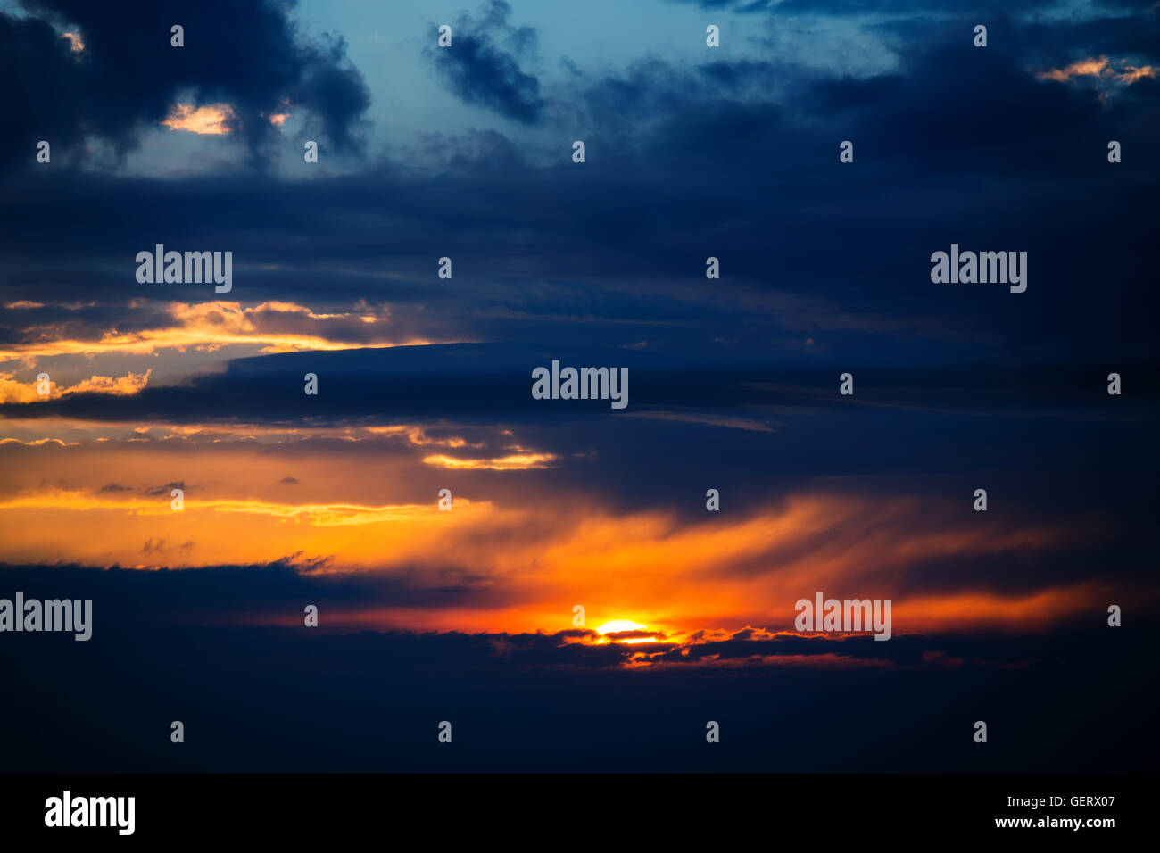 Photo of dramatic sunset with dark clouds Stock Photo