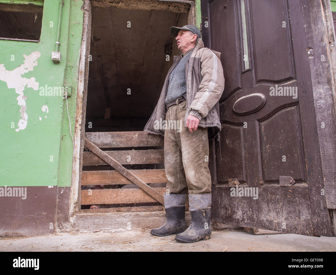 Bobrek , Poland - February 10, 2016: A polish farmer standing in front of a pigstay Stock Photo