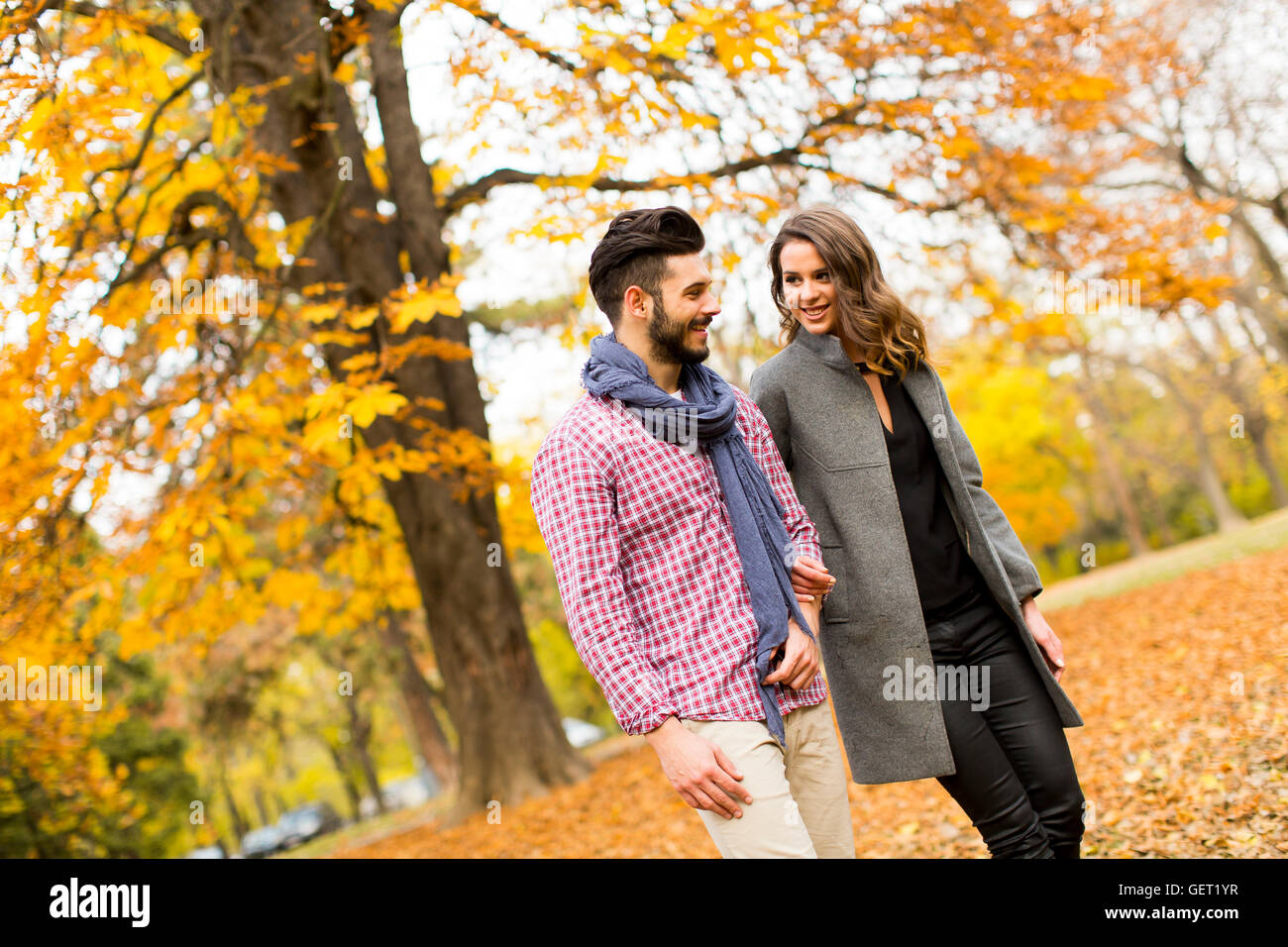 Young loving couple having a walk in the autumn park Stock Photo - Alamy