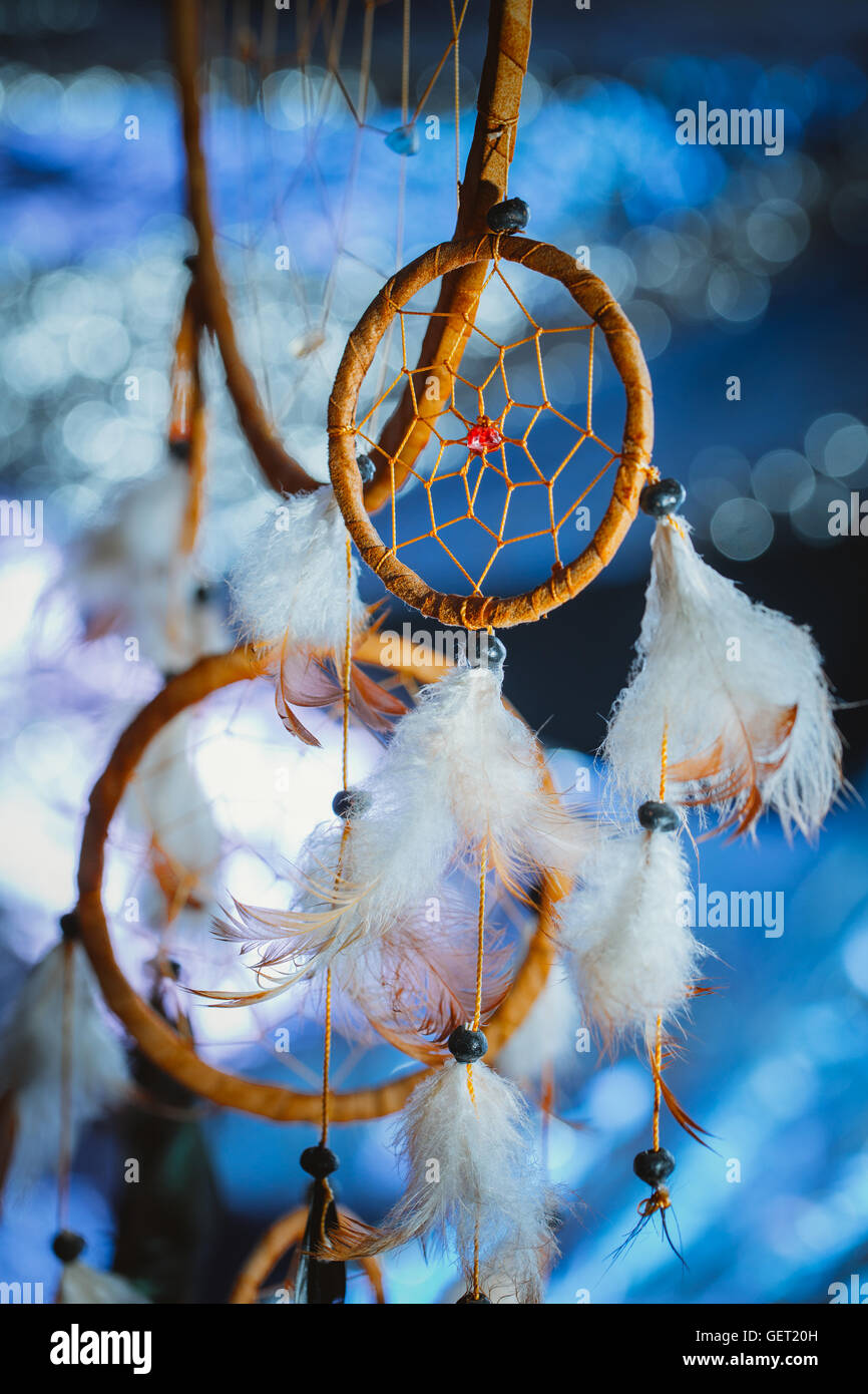 Dreamcatcher against a white blur of snow. Stock Photo