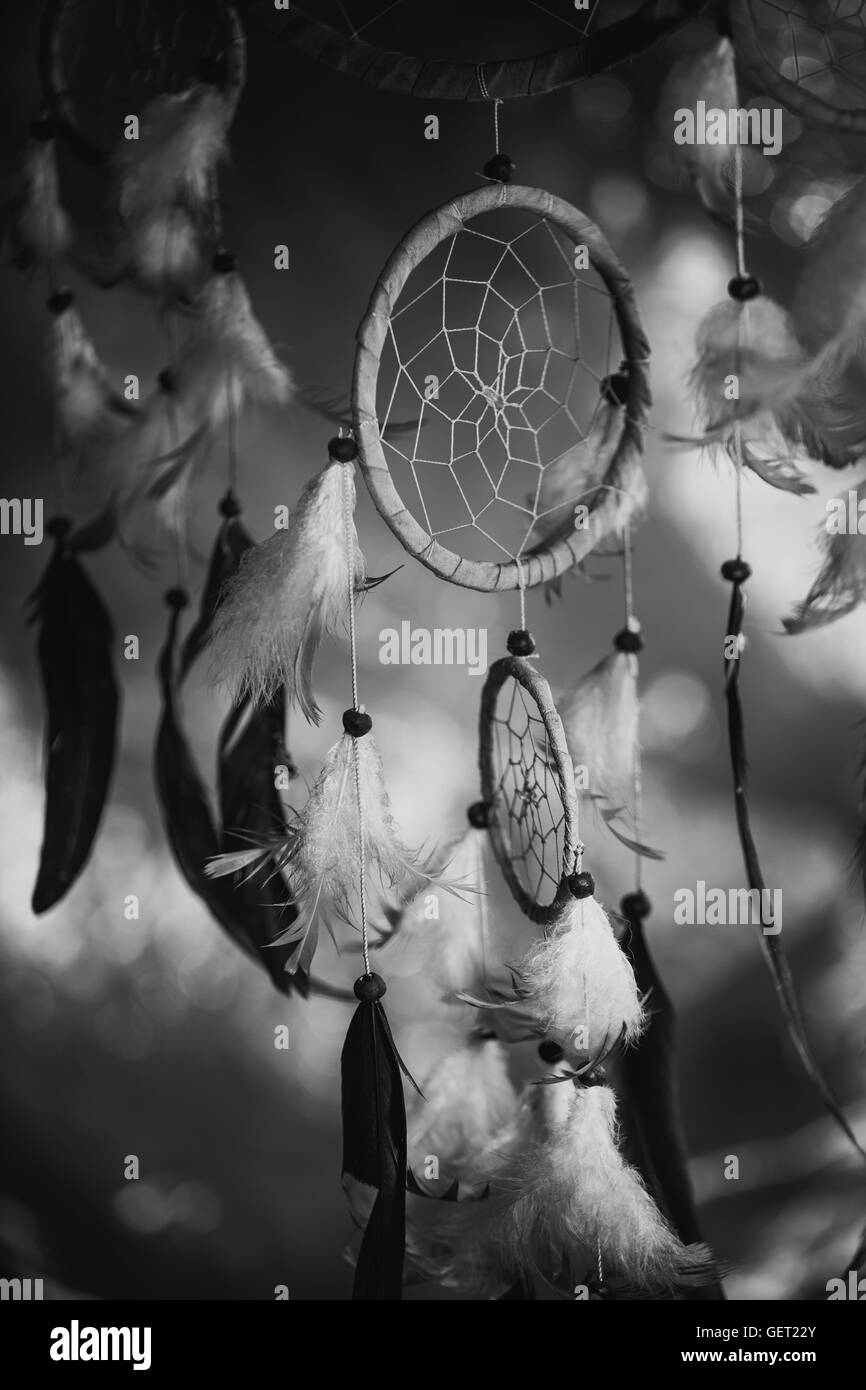 black and white photo of a dream catcher at sunset purple dark background. Stock Photo