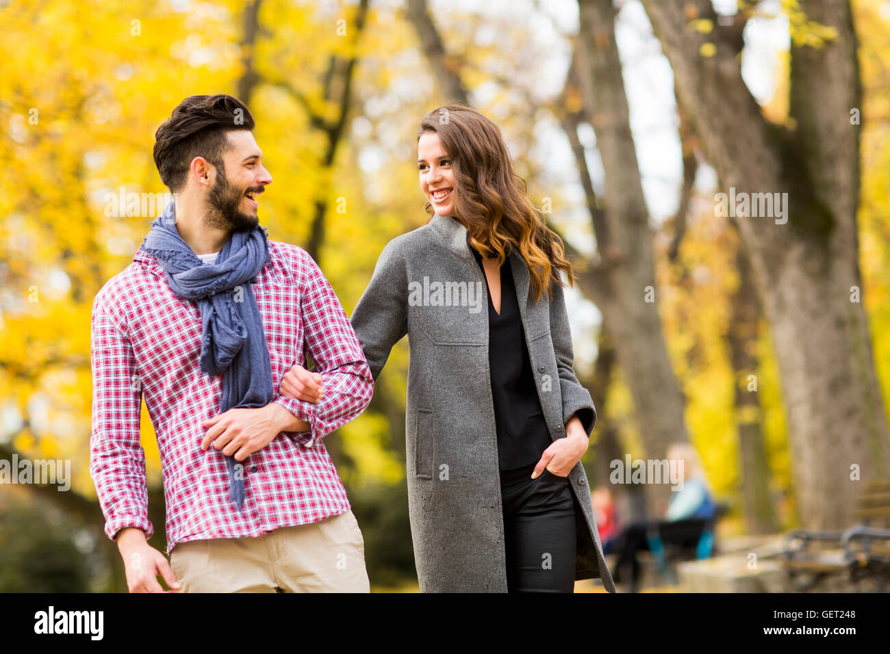 Young loving couple having a walk in the autumn park Stock Photo - Alamy