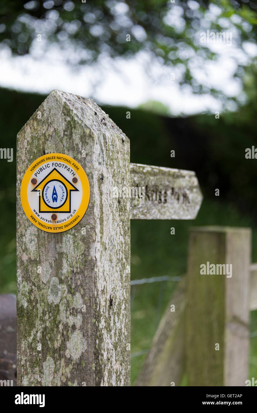 A Wooden Arrow Signpost near Bainbridge Pointing Out the Public Footpath to Askrigg in the Yorkshire Dales National Park England United Kingdom UK Stock Photo