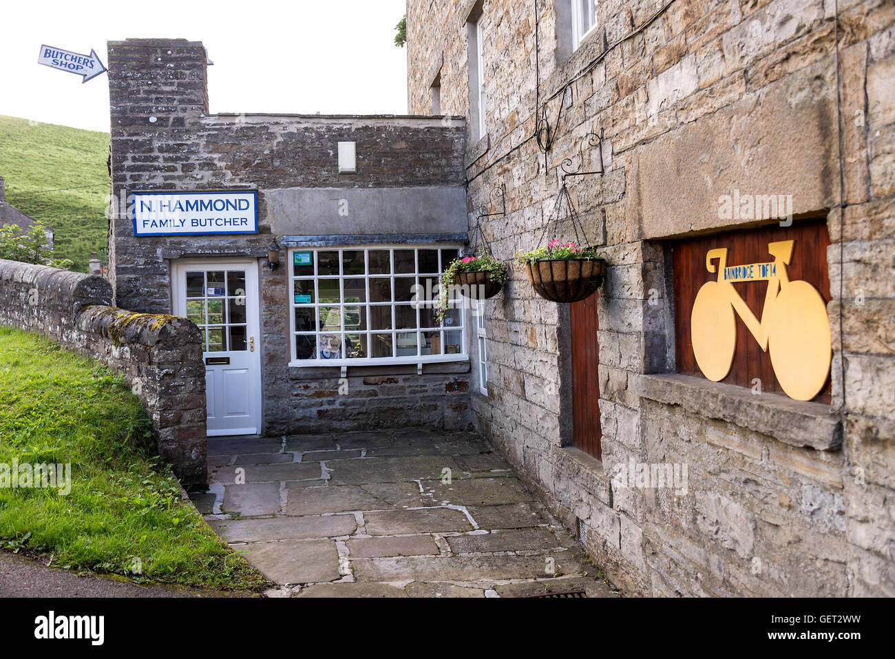 The Family Butchers Shop and Signage for the Tour de France Cycle Race in Bainbridge Yorkshire Dales National Park England United Kingdom UK Stock Photo