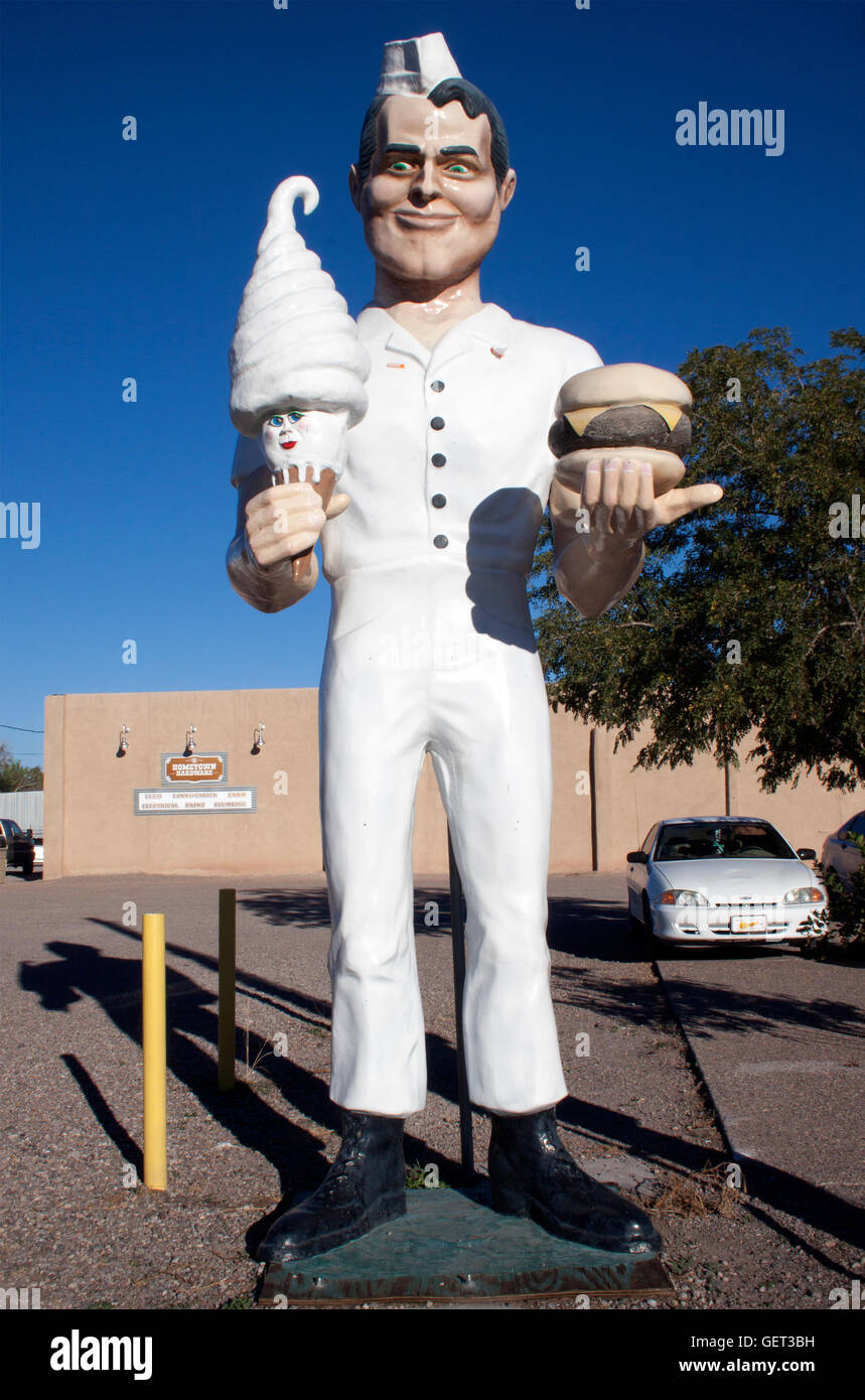 Muffler man holding an ice cream cone and hamburger outside a