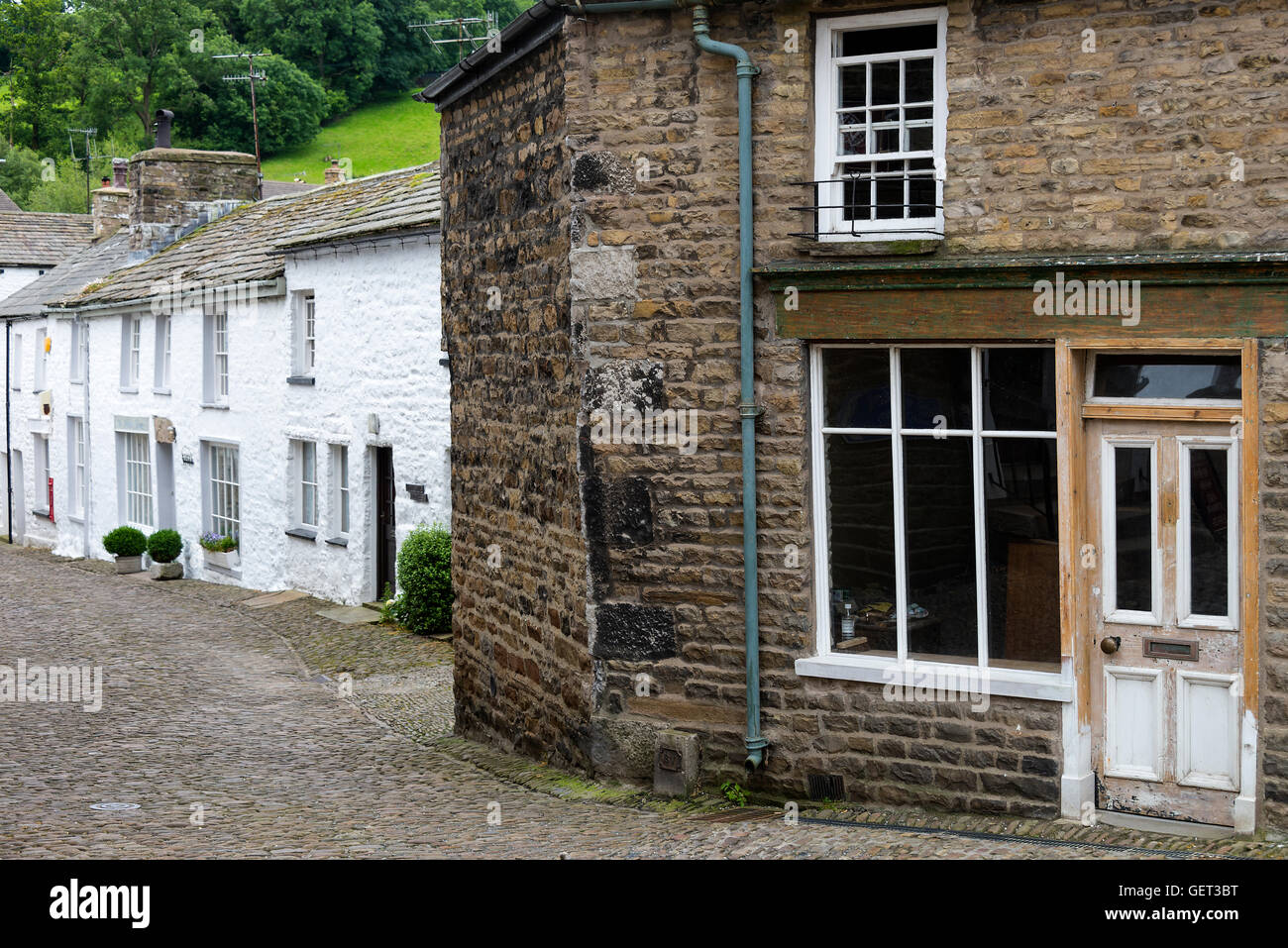 A Row of Whitewashed Cottages and an Old Shop in Dent Cumbria Yorkshire Dales National Park England United Kingdom UK Stock Photo